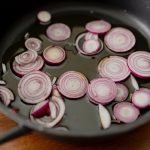 Onions in a frying pan with olive oil